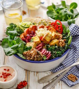 Buddha bowl of mixed vegetables,tofu cheese and groats. Healthy and nutritious vegan meal. Healthy eating concept